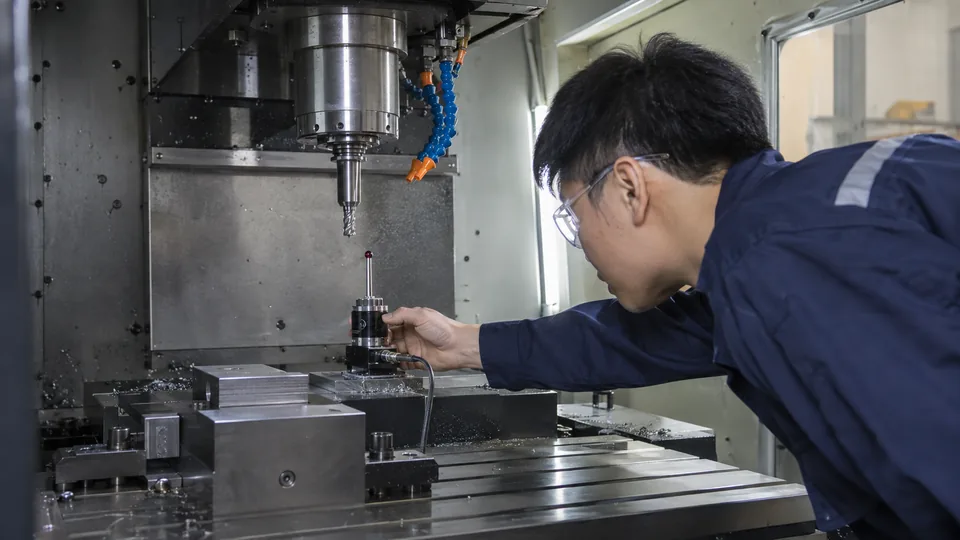 Operator checking CNC tool offsets before cutting